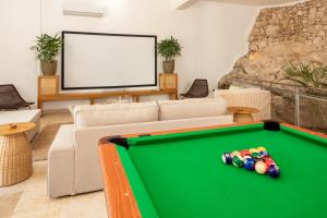 a living room with a pool table and a couch at Casa Coral Sosua in Sosúa