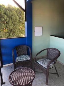 two wicker chairs sitting next to a window at Pousada Corais dos Arrecifes in São Miguel do Gostoso