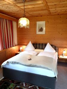 a bedroom with a large bed in a wooden room at S'Hoamatl in Hofen