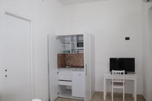 Televízia a/alebo spoločenská miestnosť v ubytovaní Il Terrazzo Sul Sinni