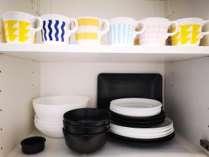 a shelf filled with plates and cups and bowls at 3 Bedroom 150 m from the beach in Torrevieja