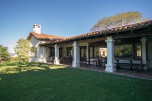 a house with a patio and a lawn at Hotel Torrontes in San Lorenzo