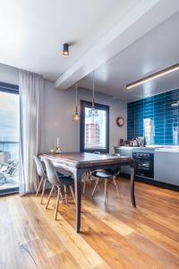 a dining room with a large wooden table and chairs at 902 Villa Luján in Mar del Plata