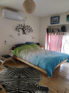a bed in a bedroom with a rug on the floor at Studio Apt Great Location Heart of Downtown District in Haifa