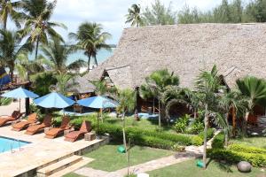 a resort with a pool and chairs and a building at Villa Dahl Beach Resort in Dar es Salaam