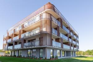 an architectural rendering of a building with balconies at Blue Mare Natura Resort z parkingiem i rowerami in Kołobrzeg