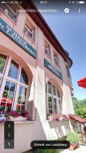 a picture of a building with flowers in the windows at Hotel & Restaurant Schenk von Landsberg in Teupitz