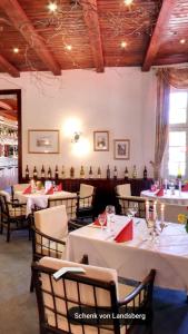 a dining room with tables and chairs with red napkins at Hotel & Restaurant Schenk von Landsberg in Teupitz +32 photos