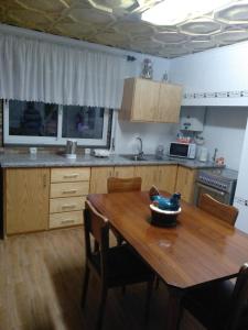 a kitchen with a wooden table with a bowl on it at Vivenda "Porto de Abrigo" in Biscoitos