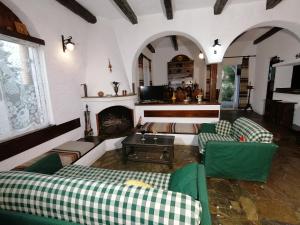 a living room with couches and a fireplace at Vasilaras Hotel in Skala