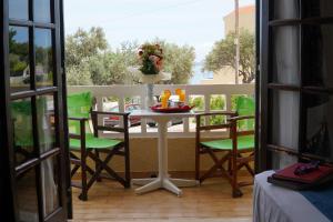 a table and chairs on a balcony with a view at Vasilaras Hotel in Skala