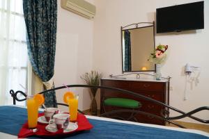 a room with a table with two glasses of orange juice at Vasilaras Hotel in Skala