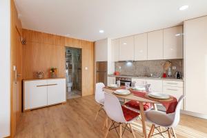a kitchen and dining room with a table and chairs at Avenida apartment 1,2 e 3 in Braga