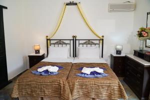 a bedroom with a bed with two towels on it at Vasilaras Hotel in Skala