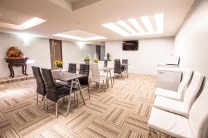 a conference room with tables and chairs and a piano at Sodamazon Business Hotel in Zhongli