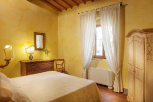 Säng eller sängar i ett rum på La Capannaccia