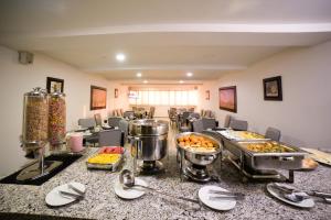 a buffet line with many different types of food at Hotel Arawak Upar in Valledupar