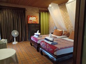 a hotel room with two beds and a fan at Sea Pines & Liberg in Nai Yang Beach +54 photos