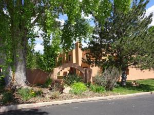 a house on the side of a street with trees at Golf course condo in Moab in Moab