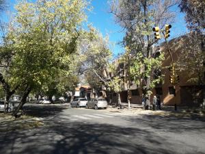 a street with cars parked on the side of the road at Apartamento Benegas in Mendoza