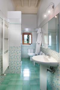 a bathroom with a sink and a toilet and a mirror at La Capannaccia in Scandicci