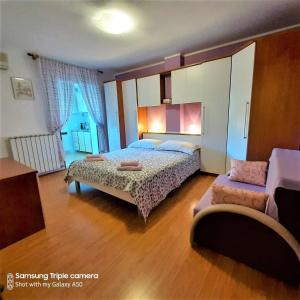 a bedroom with two beds and a couch at Apartments Elda in Rovinj