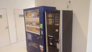 a vending machine is next to a blue refrigerator at Chura Cabin Kokusai-Dori in Naha