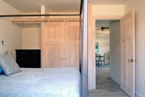 a bedroom with a bed and a open door at Valley View in Lake Cowichan