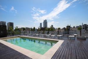 a swimming pool on the roof of a building at Palermo Soho Square in Buenos Aires