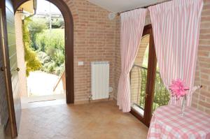 a room with a table and a large window at Cumana Blu Apartments in Campofilone