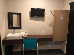 TV a/nebo společenská místnost v ubytování Hotel Raga Inn