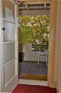 an open door leading to a patio with a table at Delatite Hotel in Mansfield