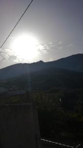 a view of the sun setting over a mountain at The Rock in Kapetanianá