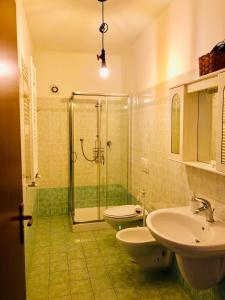 a bathroom with two toilets and a shower and a sink at I Sentieri in Rio nellʼElba +23 photos
