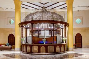 a large lobby with a round altar in a building at Corinthia Tripoli in Tripoli +54 photos