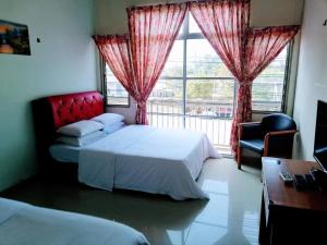 Postel nebo postele na pokoji v ubytování Daisyinn Budget Hotel Kuala Terengganu