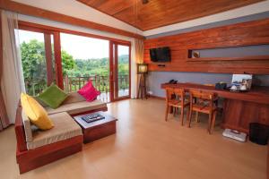 a living room with a couch and a table at Mayura Hill Resort in Sen Monorom