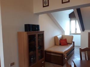 a living room with a chair and a cabinet at Villa Ida in Capo Rizzuto