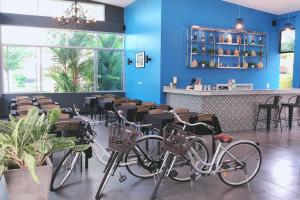 three bikes parked in a restaurant with a bar at The Malika Hotel - SHA Extra Plus in Phuket Town