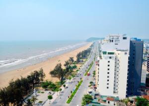 een uitzicht op een strand met een gebouw en de oceaan bij Phuong Hoang Hotel 2 in Sầm Sơn