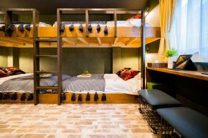 a room with two bunk beds and a couch at IKIDANE Residential Hotel Komagome in Tokyo
