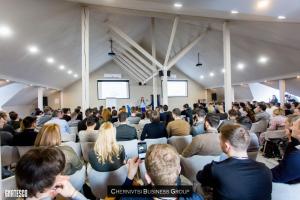 a large group of people sitting in a room at Rivoli Hotel in Chernivtsi