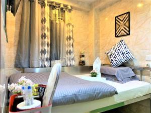 Ένα ή περισσότερα κρεβάτια σε δωμάτιο στο Super Guest House