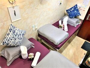 Ένα ή περισσότερα κρεβάτια σε δωμάτιο στο Super Guest House