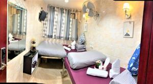 Ένα ή περισσότερα κρεβάτια σε δωμάτιο στο Super Guest House