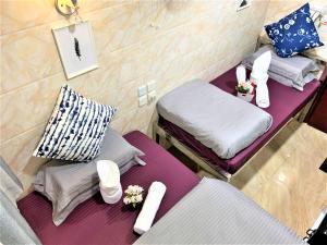 Ένα ή περισσότερα κρεβάτια σε δωμάτιο στο Super Guest House