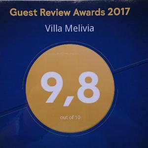 a sign that reads quest review awards villa melilla at Villa Melivia in Hersonissos