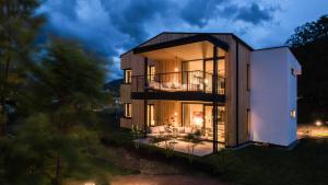 a house with a view of the exterior at night at Cirna Gentle Luxury Lodges in Naturno