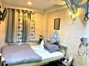 Ένα ή περισσότερα κρεβάτια σε δωμάτιο στο Super Guest House