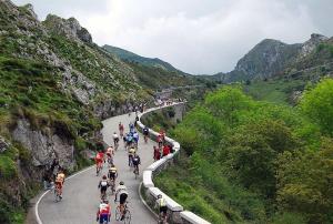 a large group of people riding bikes down a road at Apartamentos El Castañeu in Corao
